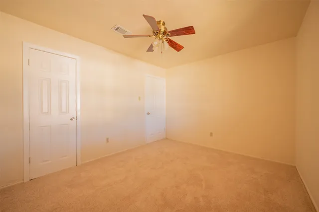 a view of room with a ceiling fan and a window