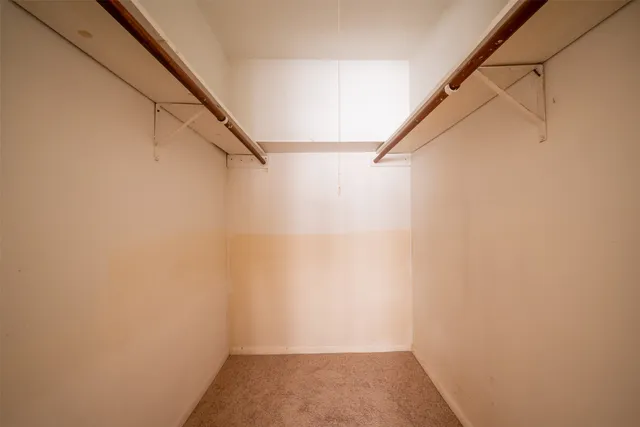 a front view of a house with a garden and tree