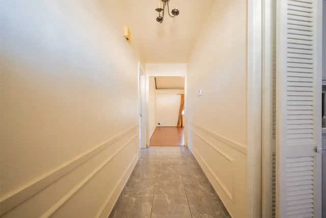 a view of a hallway with a white walls