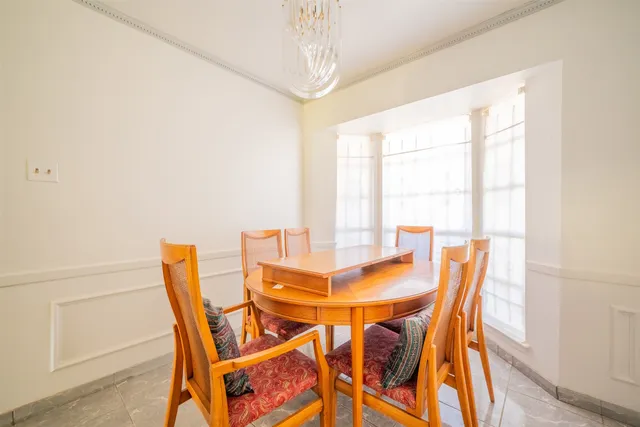 a view of a dining room with furniture and a window