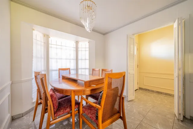 a view of a dining room with furniture and window