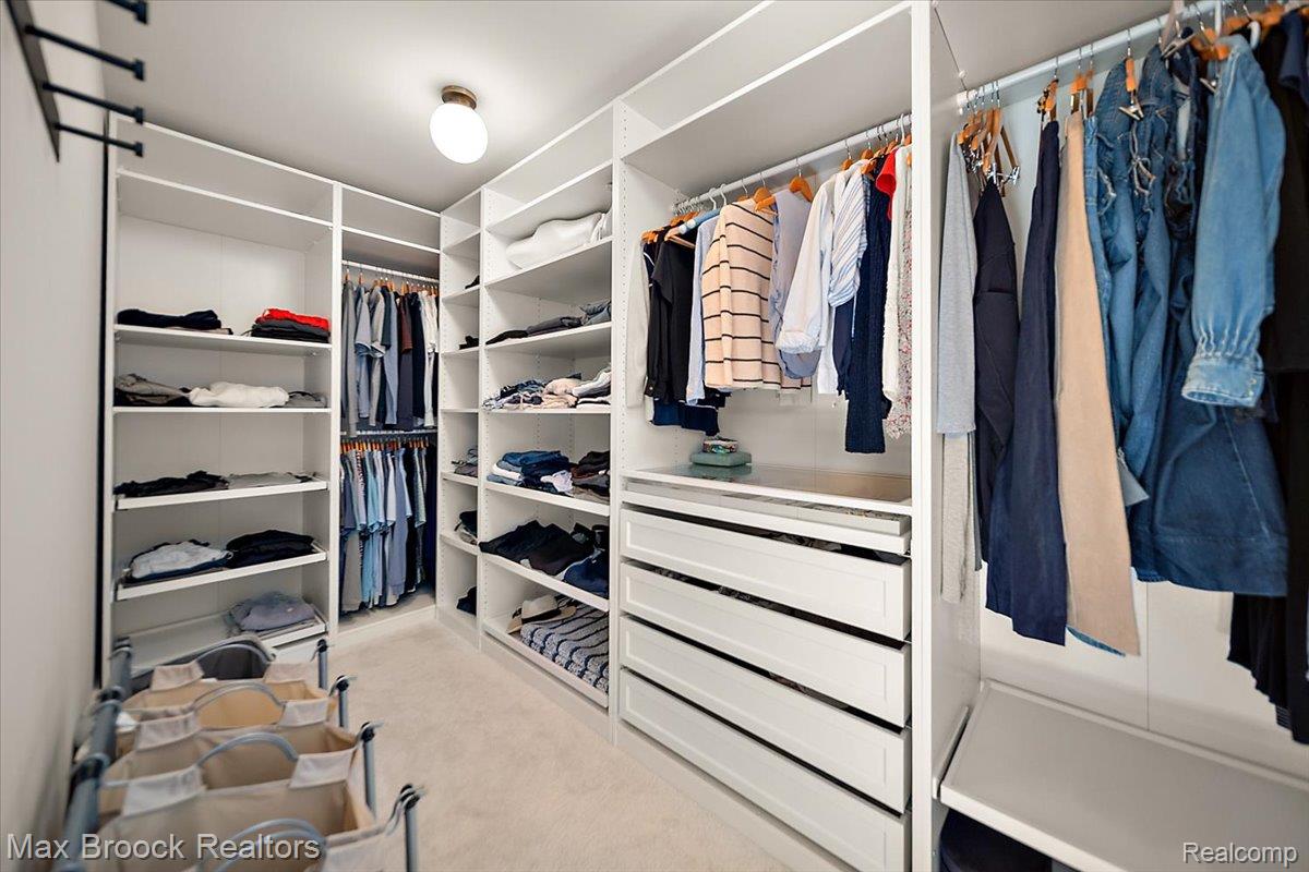 1942 Nottingham Drive Rochester, MI 48307 - Photo 66 of 97 Custom closet system featuring extensive shelving, multiple hanging rods, integrated drawers, and a ceiling-mounted light fixture