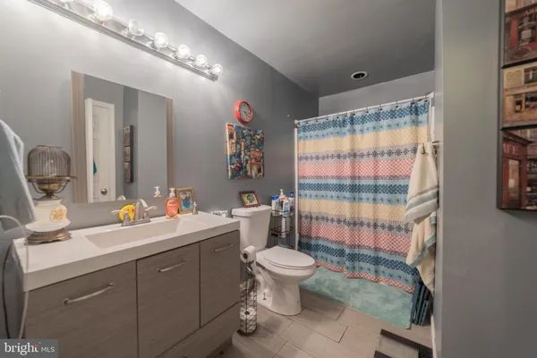 a bathroom with a double vanity sink toilet and shower