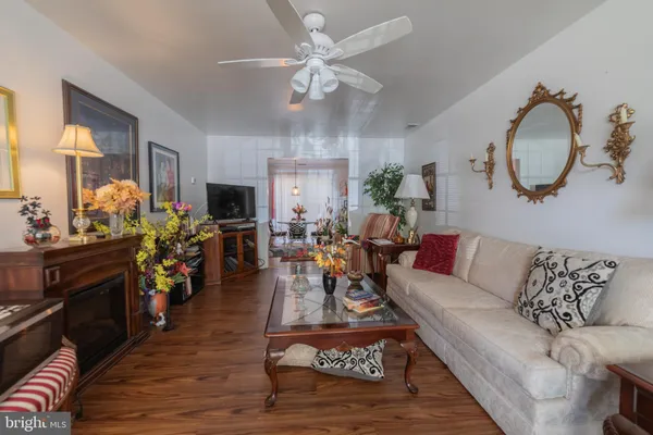 a living room with furniture kitchen view and a fireplace