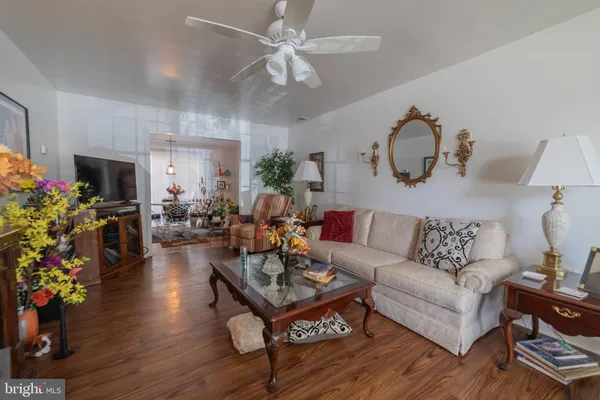 a living room with furniture a chandelier and a fireplace