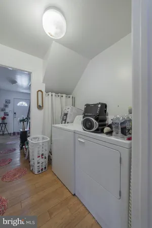 a view of a storage & utility room with two washing machine