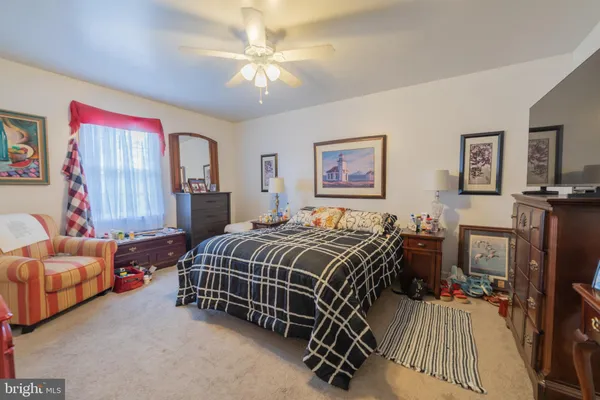 a bedroom with a bed and a couch