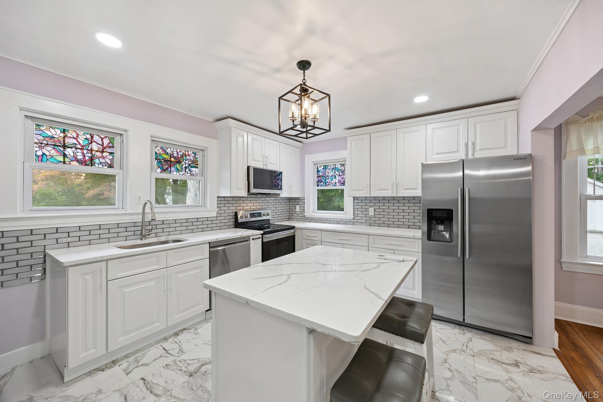 1235 Post Road Scarsdale, NY 10583 - Photo 13 of 30 Kitchen featuring stainless steel appliances, plenty of natural light, tasteful backsplash, white cabinetry, and recessed lighting