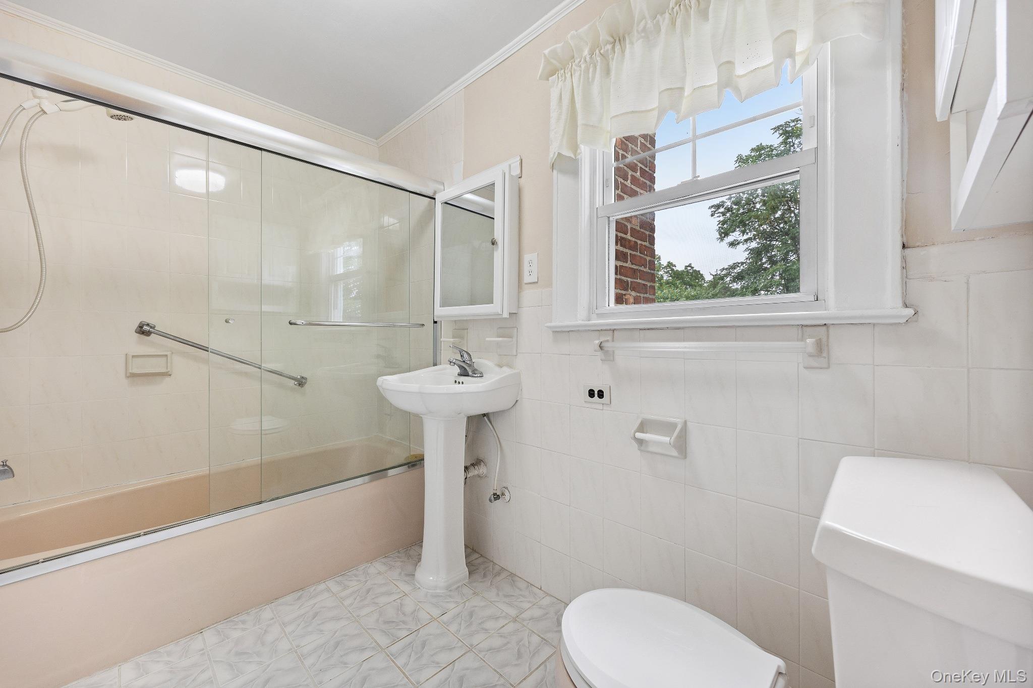 1235 Post Road Scarsdale, NY 10583 - Photo 19 of 30 Full bath featuring crown molding and shower / bath combination with glass door