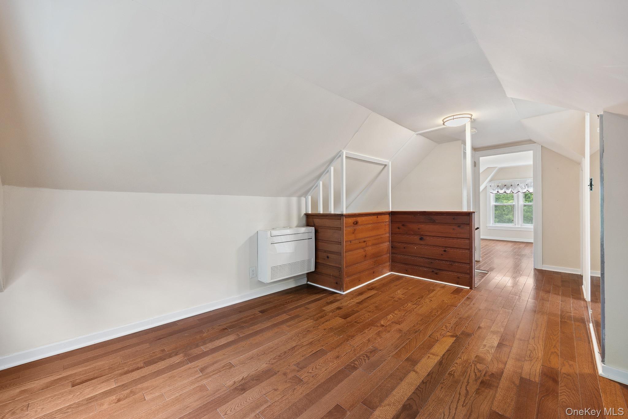 1235 Post Road Scarsdale, NY 10583 - Photo 23 of 30 Additional living space with hardwood / wood-style flooring, heating unit, and lofted ceiling