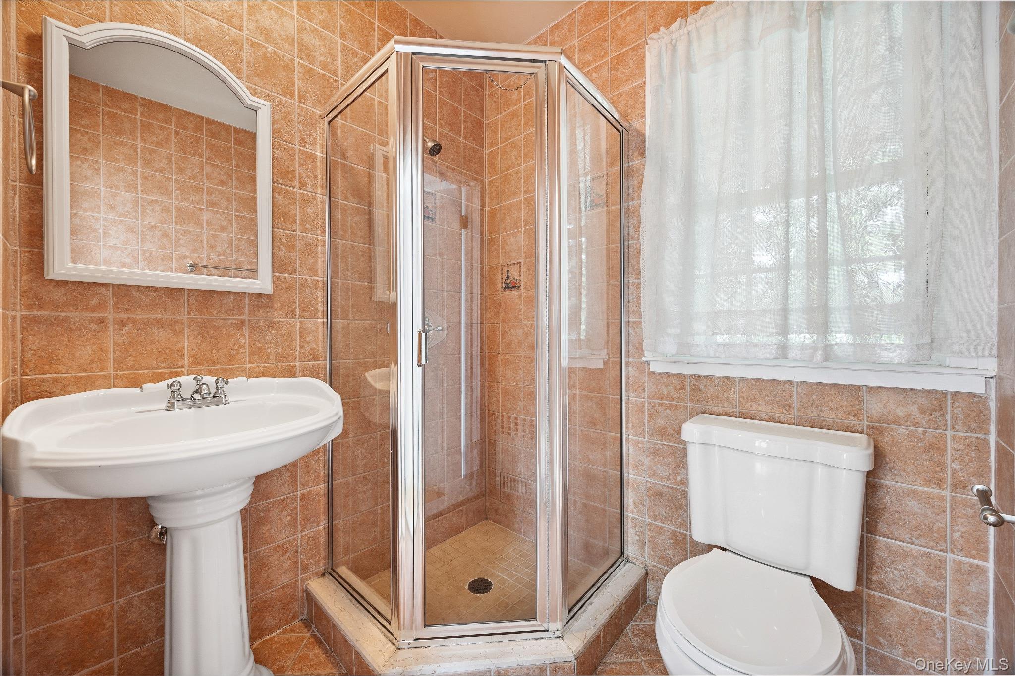 1235 Post Road Scarsdale, NY 10583 - Photo 9 of 30 Bathroom featuring tile walls and a stall shower