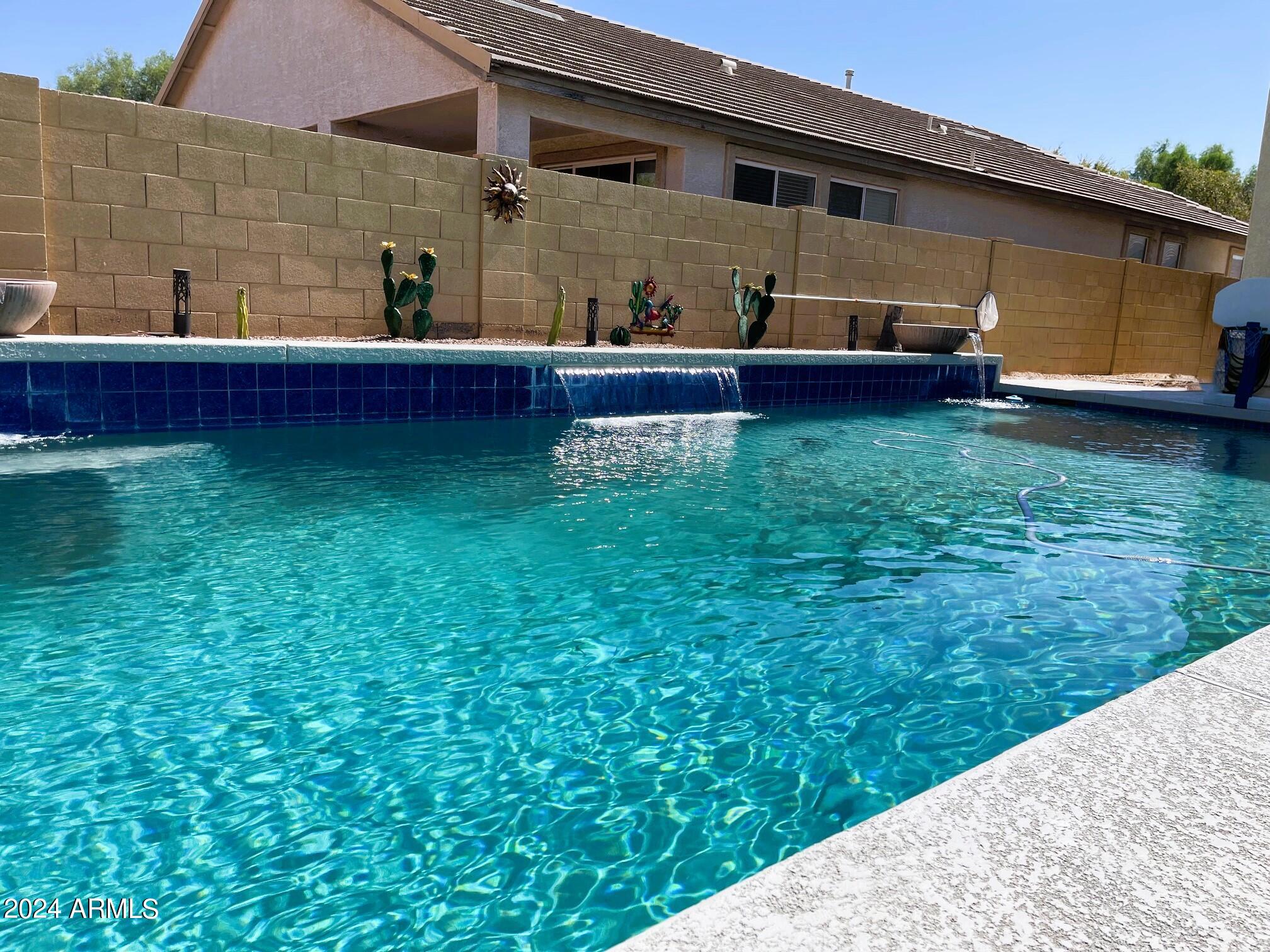 14988 West Bloomfield Road Surprise, AZ 85379 - Photo 28 of 34 Pool with water feature at Bloomfield CS