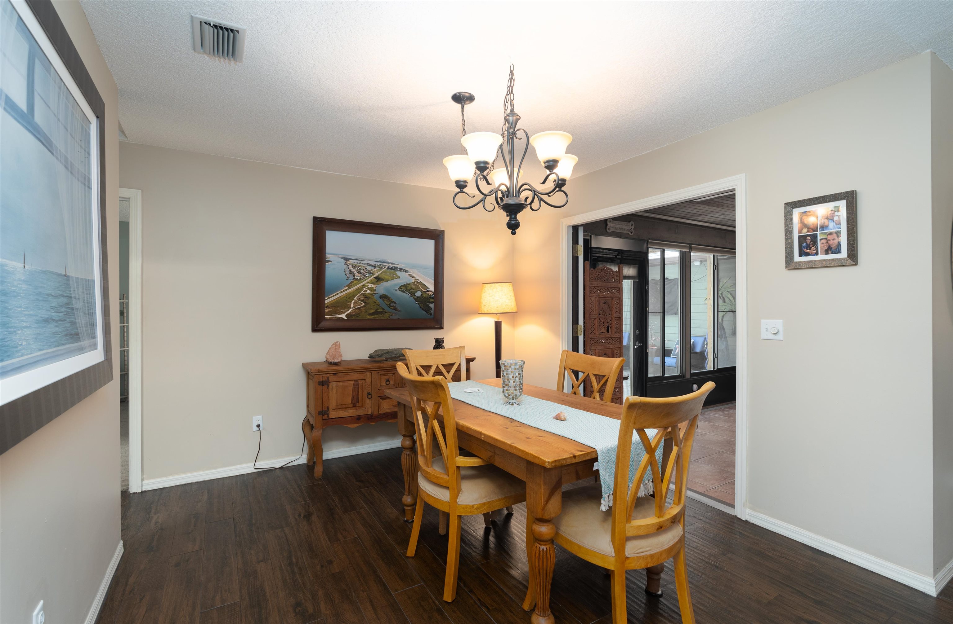 4260 Wicks Branch Road St. Augustine, FL 32086 - Photo 11 of 31 a view of a dining room with furniture and wooden floor
