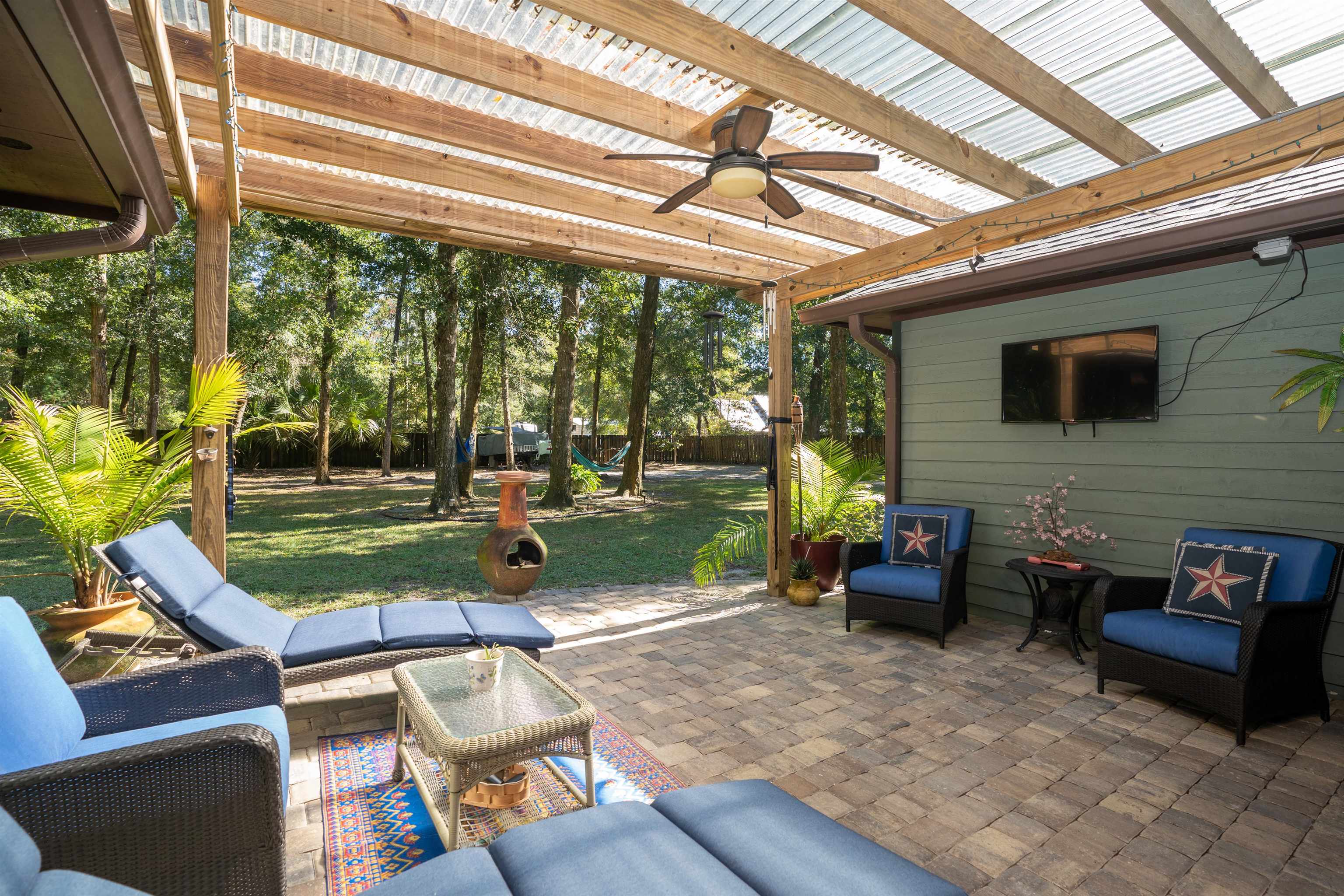 4260 Wicks Branch Road St. Augustine, FL 32086 - Photo 14 of 31 a living room with patio furniture and a floor to ceiling window