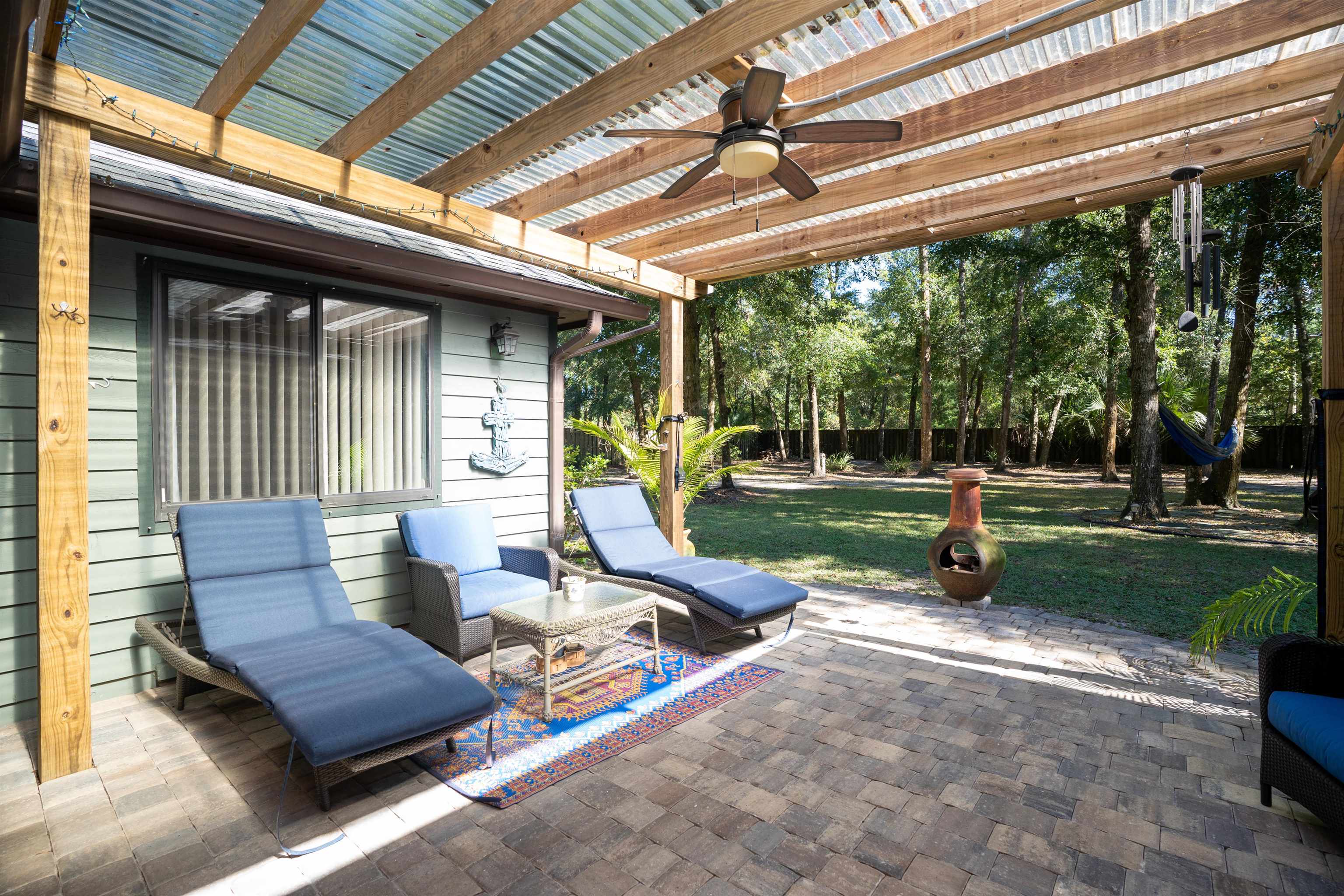 4260 Wicks Branch Road St. Augustine, FL 32086 - Photo 15 of 31 a view of a deck with couches chairs and a yard
