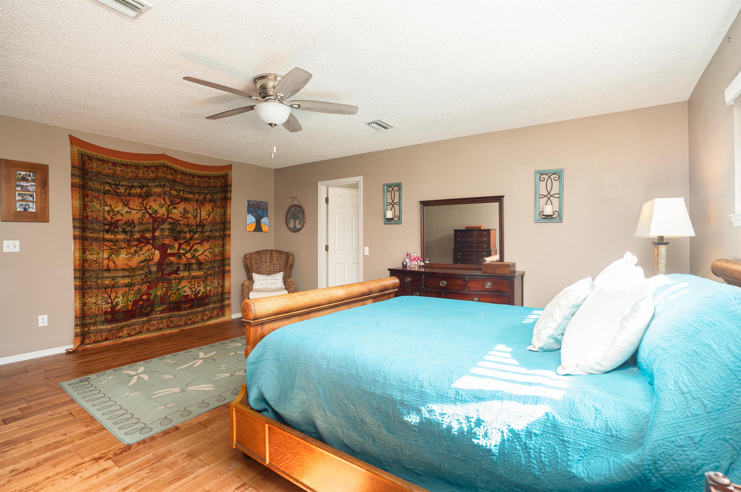 4260 Wicks Branch Road St. Augustine, FL 32086 - Photo 17 of 31 a spacious bedroom with a bed and a flat screen tv