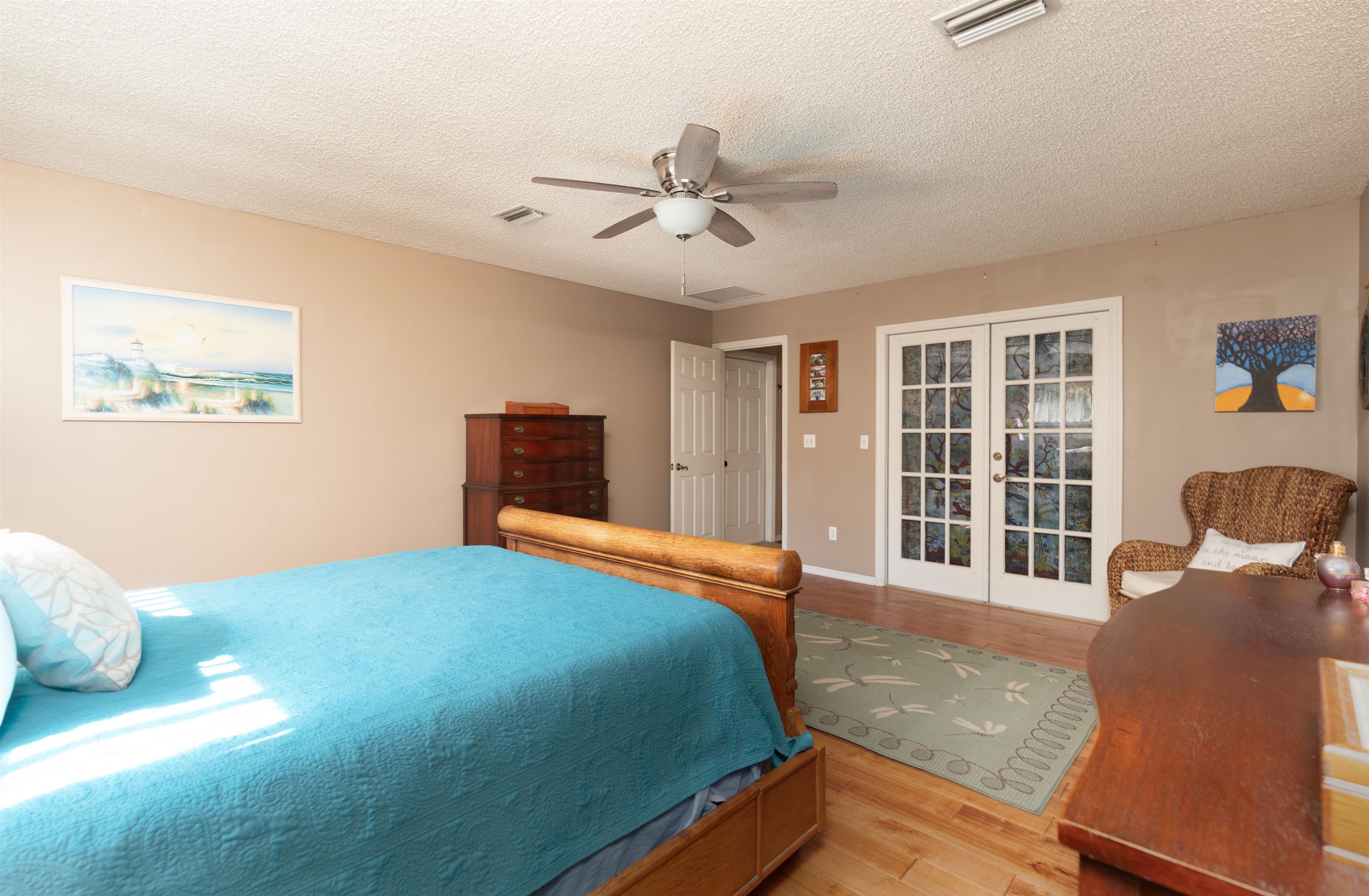4260 Wicks Branch Road St. Augustine, FL 32086 - Photo 18 of 31 a bedroom with a bed and wooden floor
