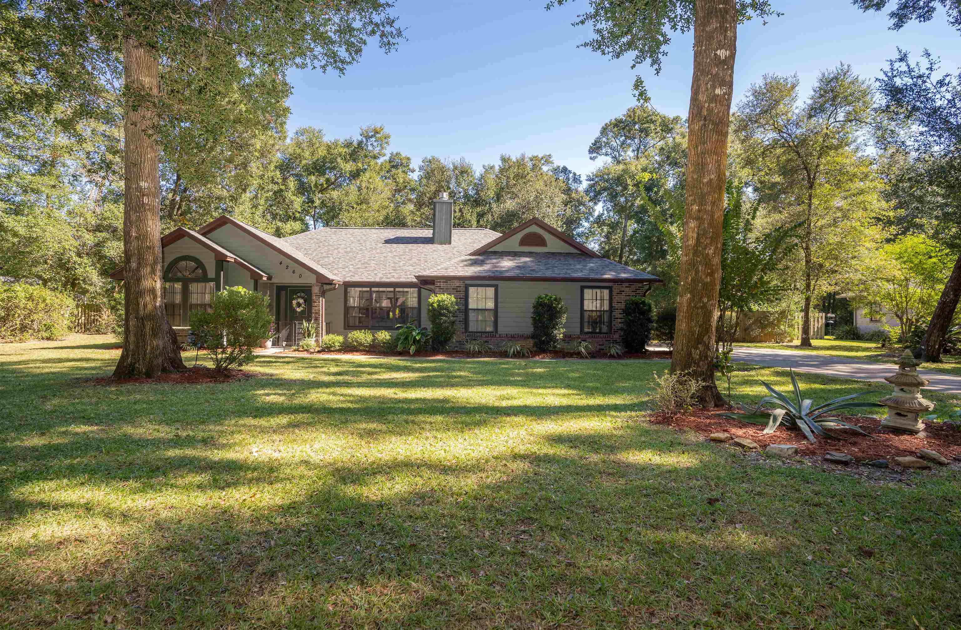 4260 Wicks Branch Road St. Augustine, FL 32086 - Photo 3 of 31 a front view of a house with a yard table and chairs