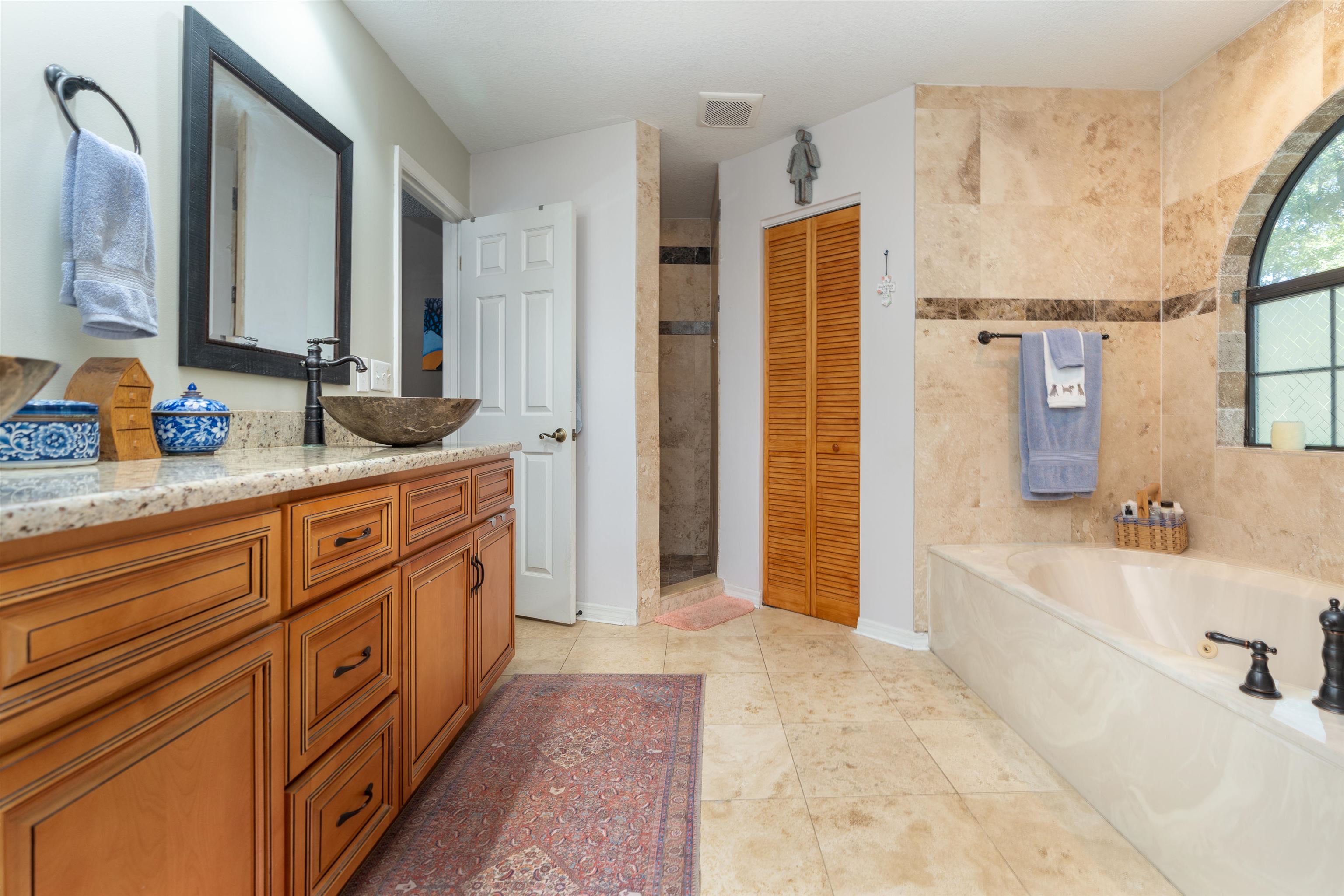 4260 Wicks Branch Road St. Augustine, FL 32086 - Photo 21 of 31 a spacious bathroom with a double vanity sink a mirror and a bathtub
