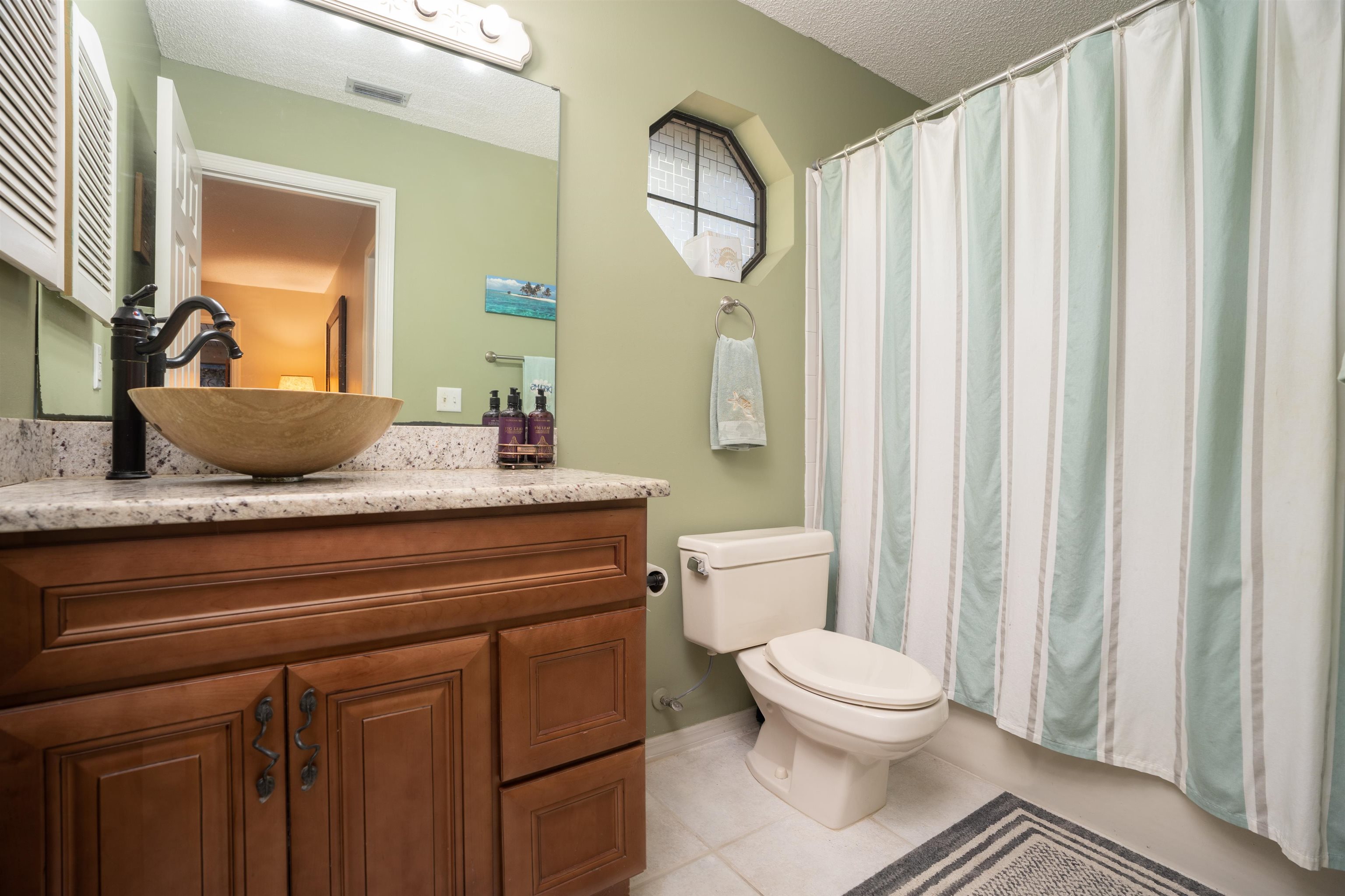 4260 Wicks Branch Road St. Augustine, FL 32086 - Photo 24 of 31 a bathroom with a toilet a sink and a mirror