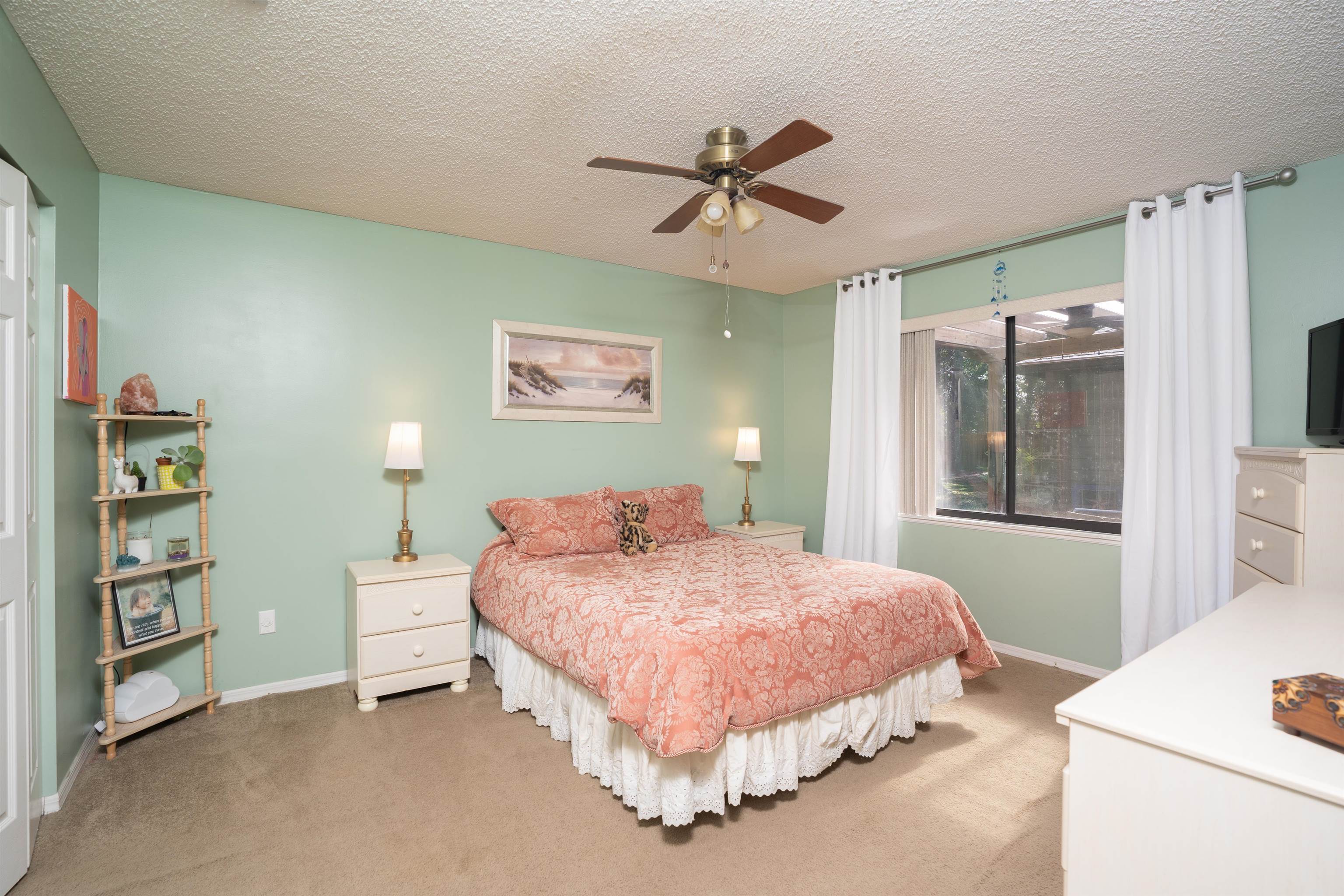 4260 Wicks Branch Road St. Augustine, FL 32086 - Photo 25 of 31 a bedroom with a bed dresser and a window