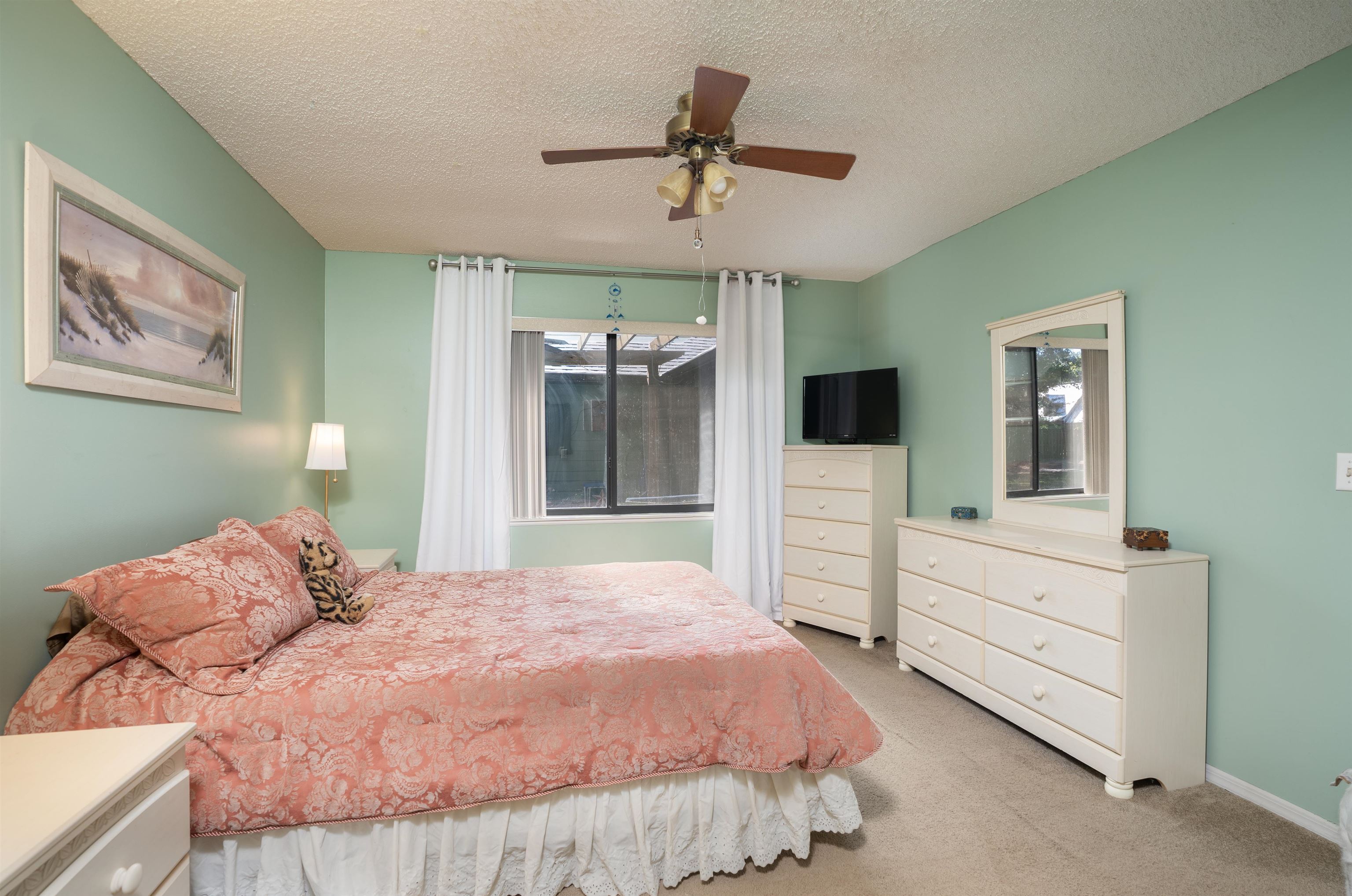 4260 Wicks Branch Road St. Augustine, FL 32086 - Photo 26 of 31 a bedroom with a bed and a flat screen tv