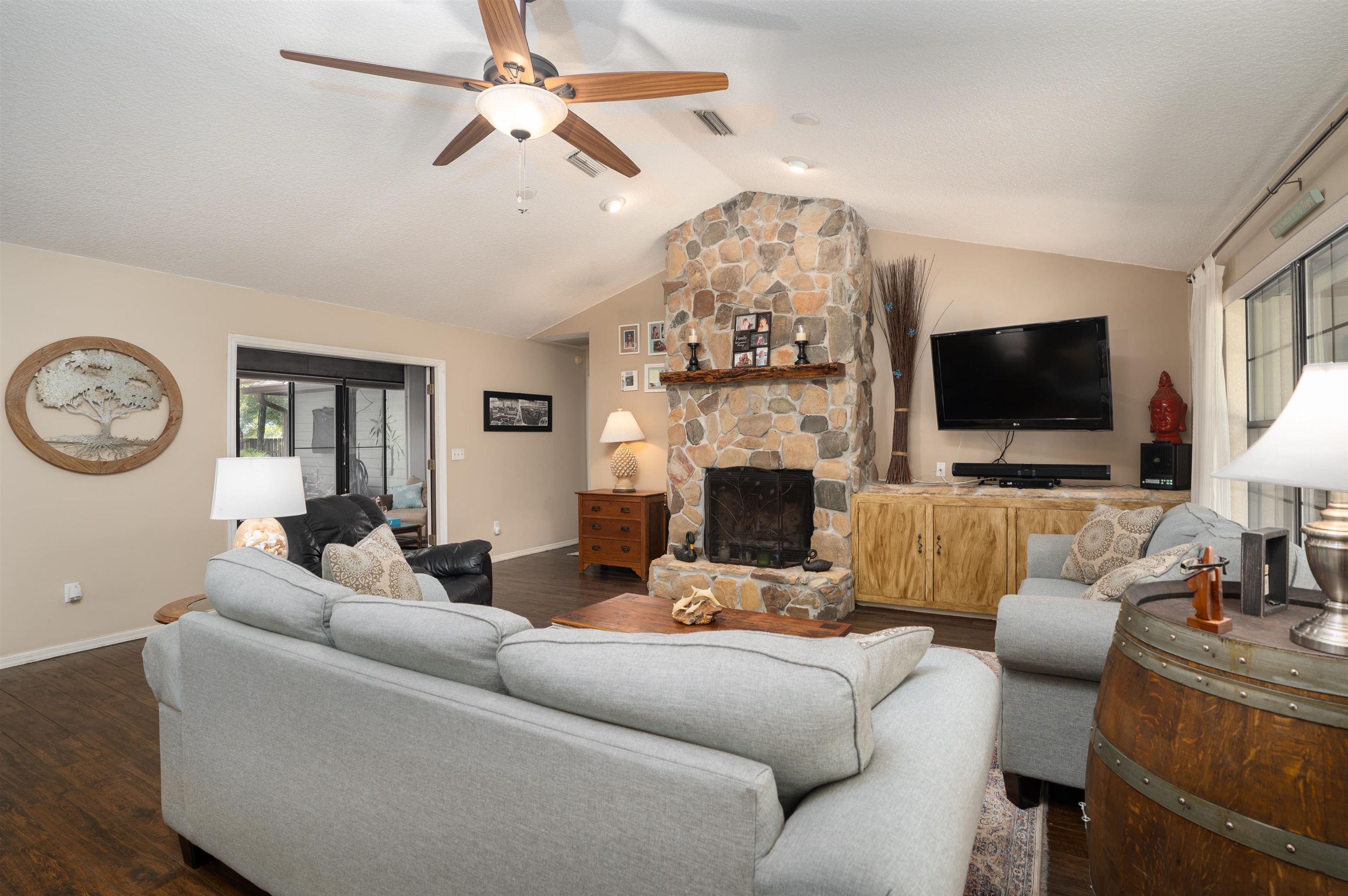 4260 Wicks Branch Road St. Augustine, FL 32086 - Photo 6 of 31 a living room with furniture a fireplace and a flat screen tv
