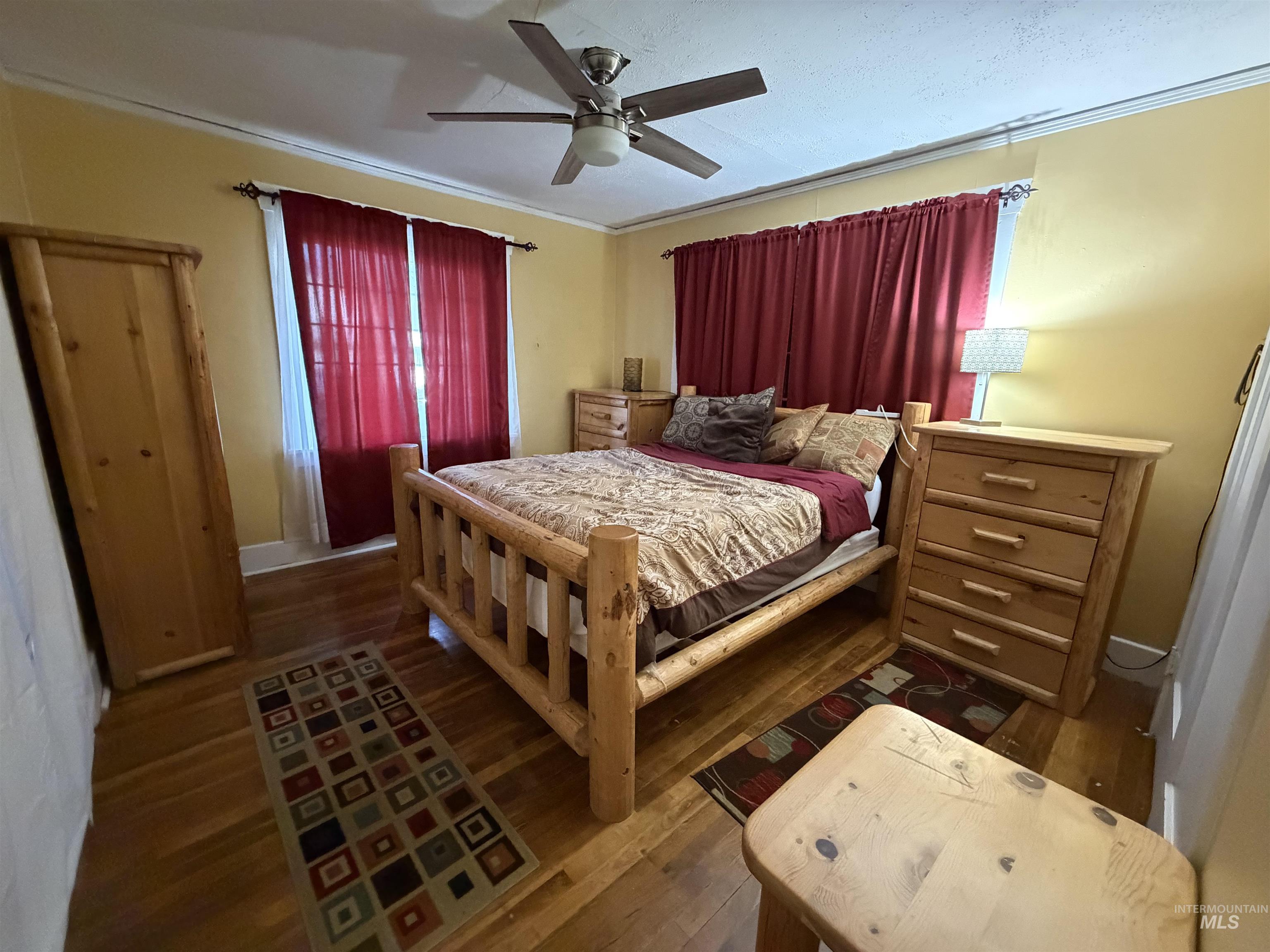 410 12th Street Lewiston, ID 83501 - Photo 12 of 38 Bedroom featuring dark wood-style flooring, a ceiling fan, and ornamental molding