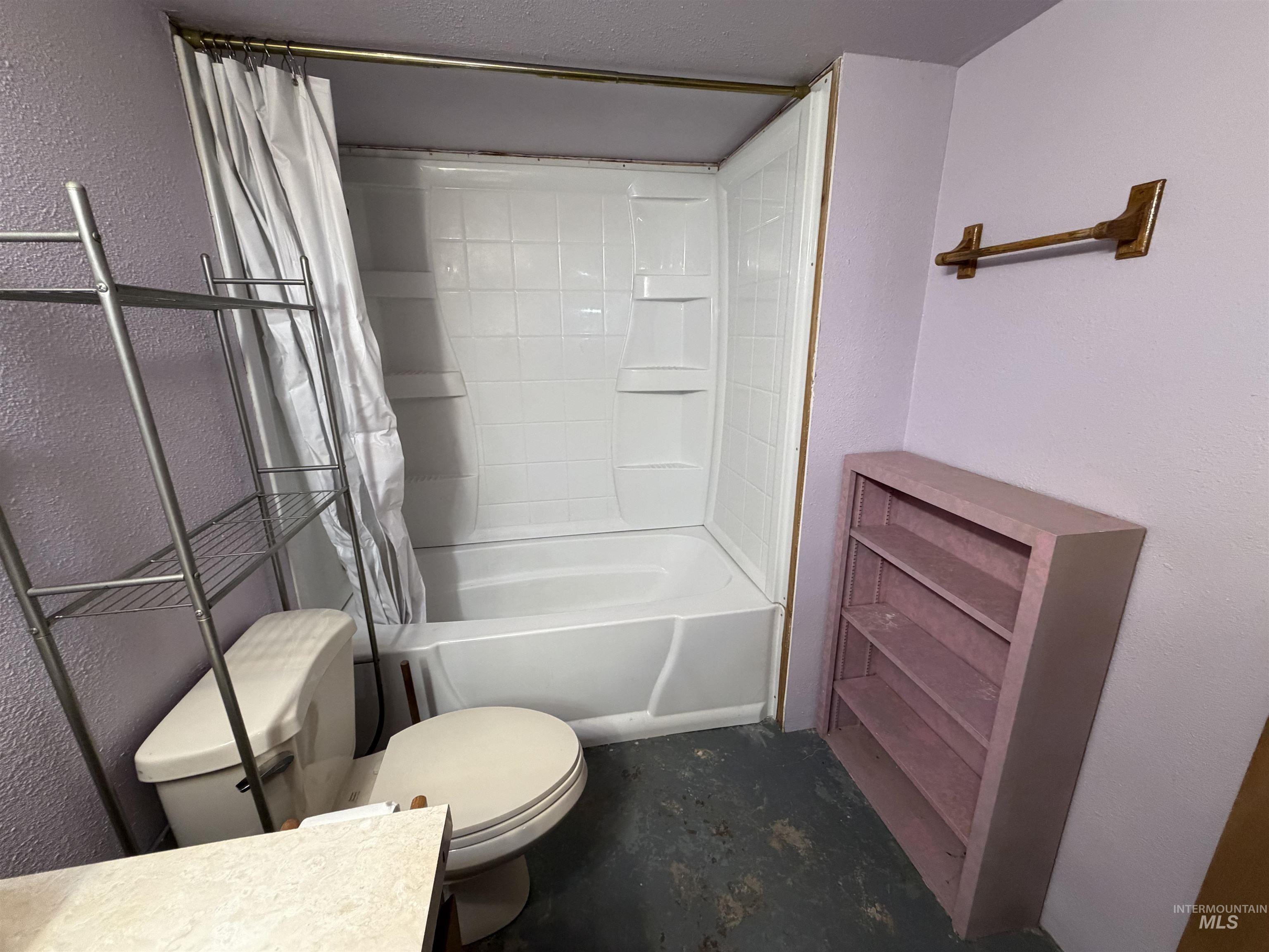 410 12th Street Lewiston, ID 83501 - Photo 28 of 38 Full bathroom with a textured wall, shower / bathtub combination with curtain, concrete floors, and vanity