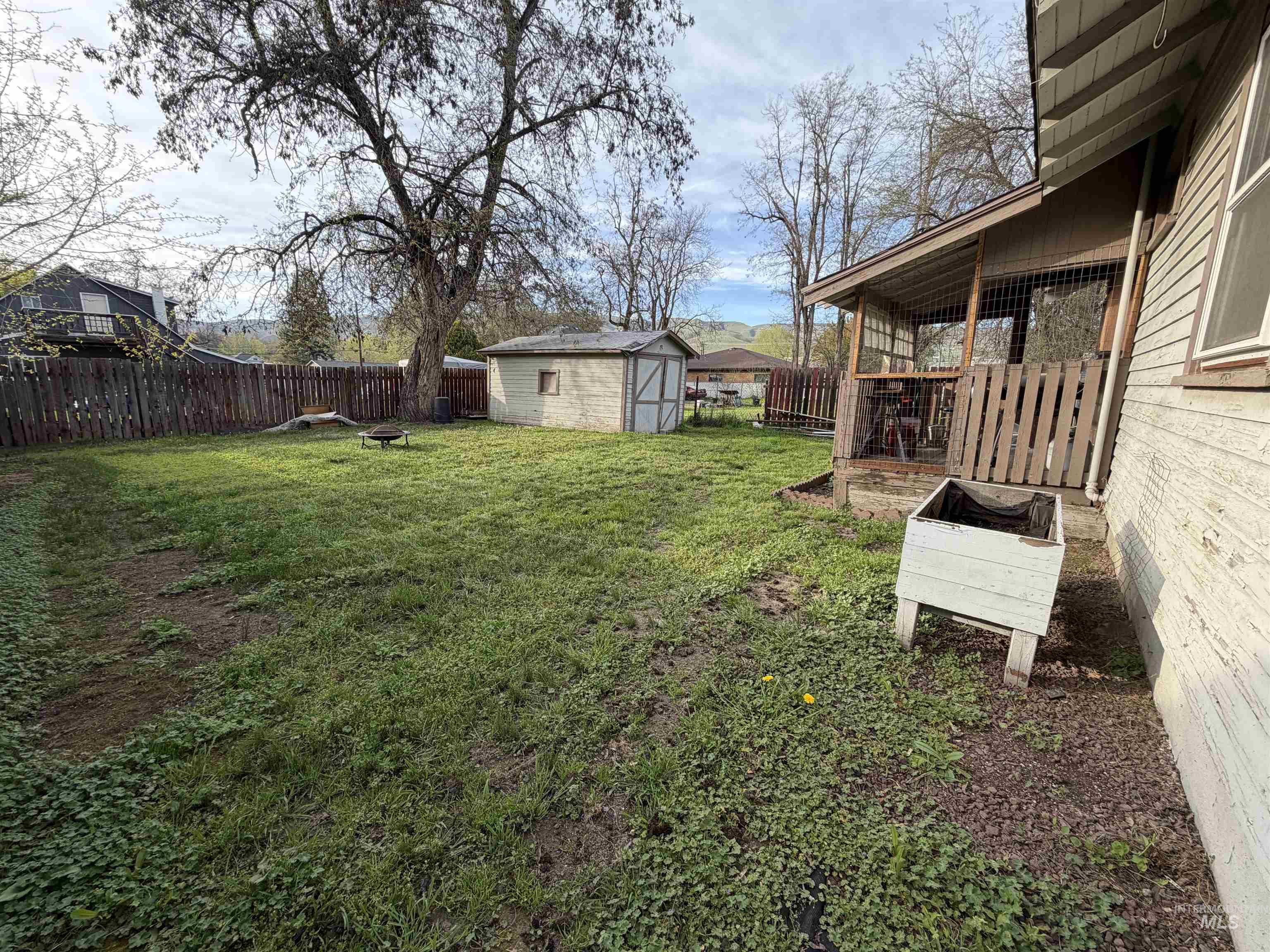 410 12th Street Lewiston, ID 83501 - Photo 33 of 38 Fenced backyard with an outdoor fire pit and a shed