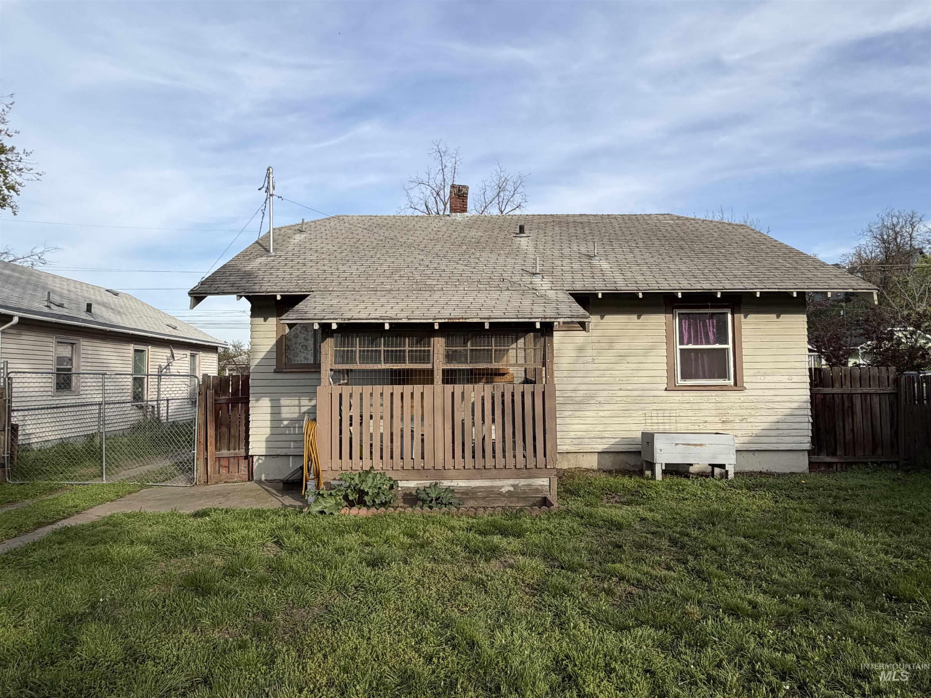 410 12th Street Lewiston, ID 83501 - Photo 36 of 38 Back of house with a shingled roof, a fenced backyard, and a chimney