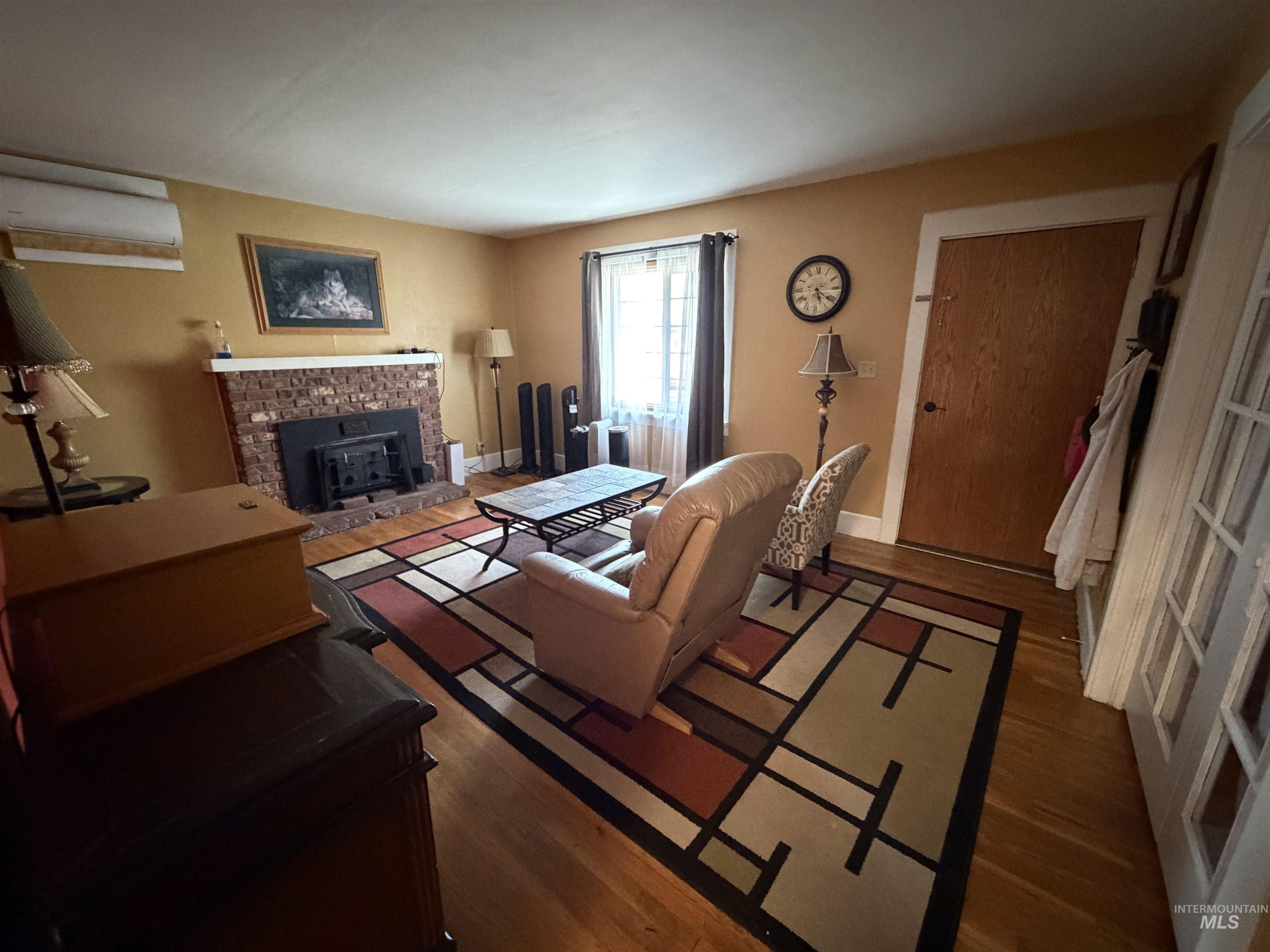 410 12th Street Lewiston, ID 83501 - Photo 10 of 38 Living area featuring dark wood-style floors and a fireplace