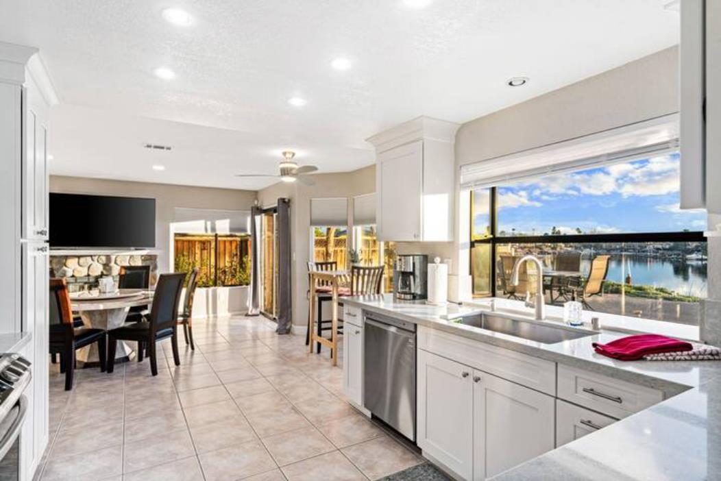 2066 Sand Point Road Discovery Bay, CA 94505 - Photo 11 of 36 a kitchen with stainless steel appliances kitchen island granite countertop a sink and cabinets