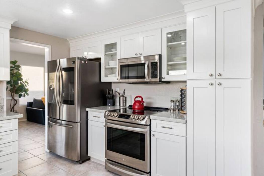 2066 Sand Point Road Discovery Bay, CA 94505 - Photo 15 of 36 a kitchen with stainless steel appliances a refrigerator stove and microwave