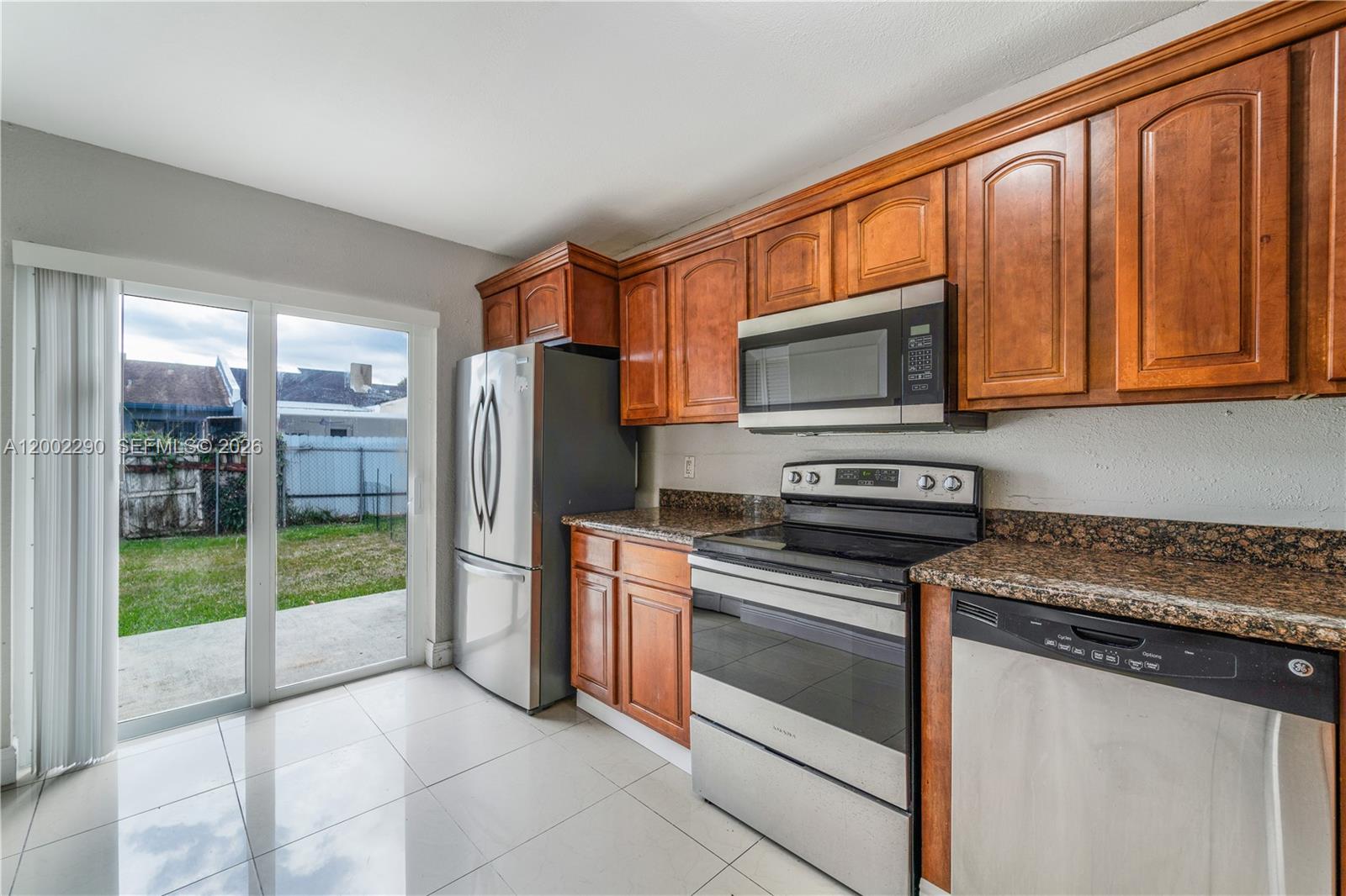 11310 Southwest 189th Street, Unit 11310 Miami, FL 33157 - Photo 1 of 24 a kitchen with stainless steel appliances granite countertop a refrigerator stove and microwave