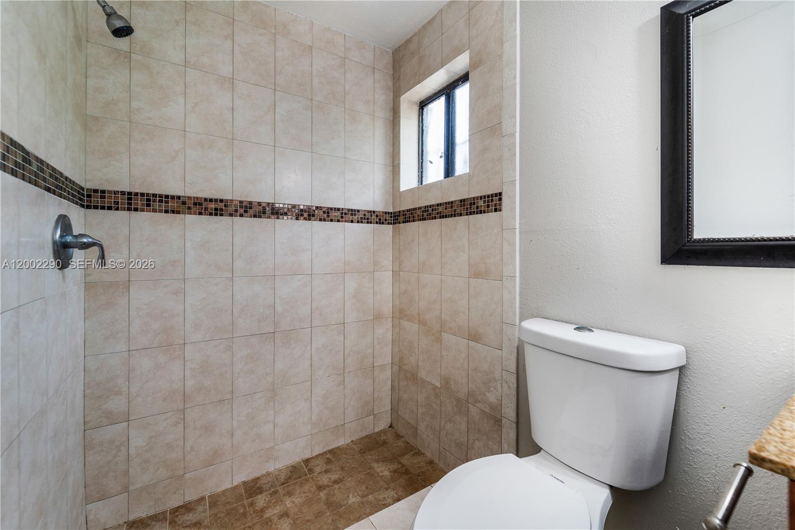 11310 Southwest 189th Street, Unit 11310 Miami, FL 33157 - Photo 13 of 24 a white toilet sitting next to a shower