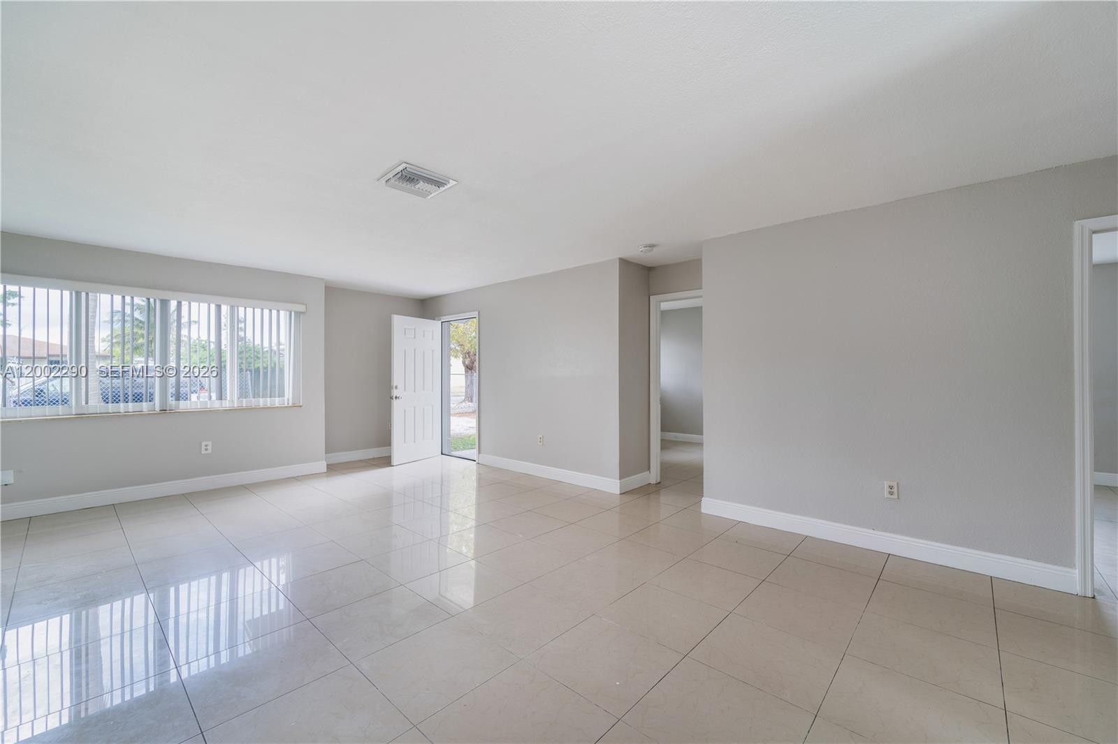 11310 Southwest 189th Street, Unit 11310 Miami, FL 33157 - Photo 16 of 24 a view of an empty room with a window