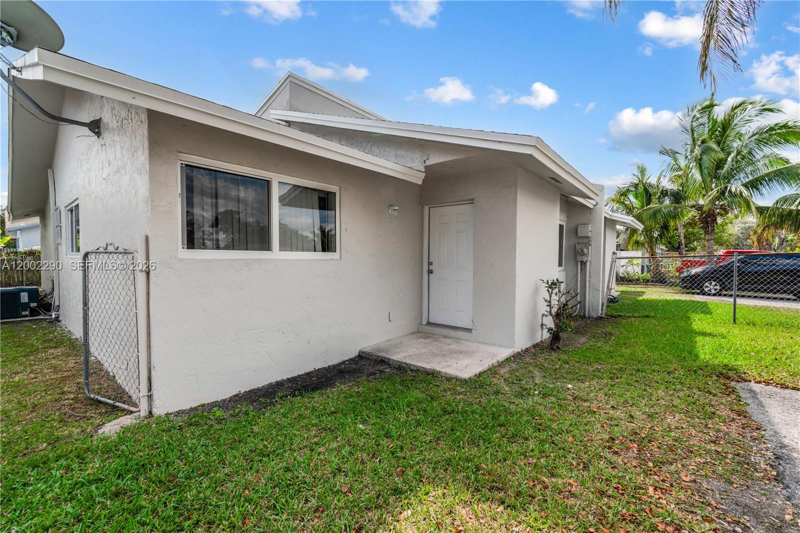 11310 Southwest 189th Street, Unit 11310 Miami, FL 33157 - Photo 3 of 24 a view of front of house with a yard