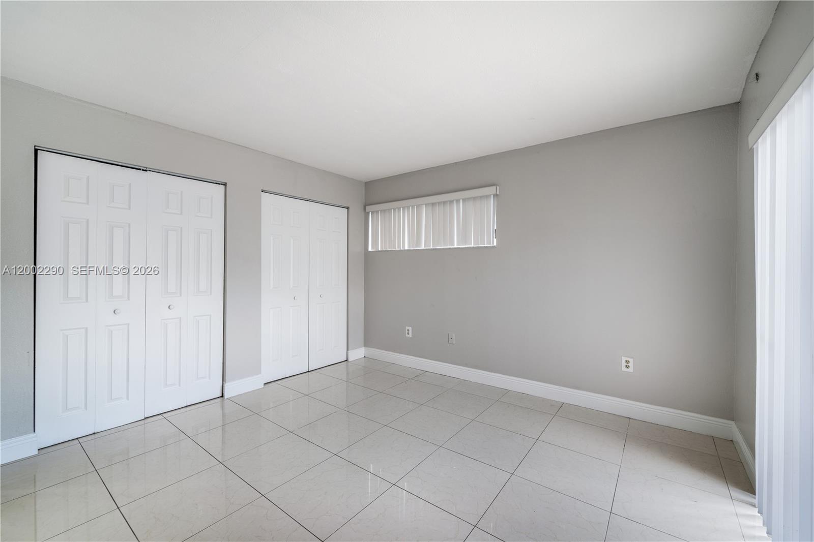 11310 Southwest 189th Street, Unit 11310 Miami, FL 33157 - Photo 5 of 24 a view of an empty room and window