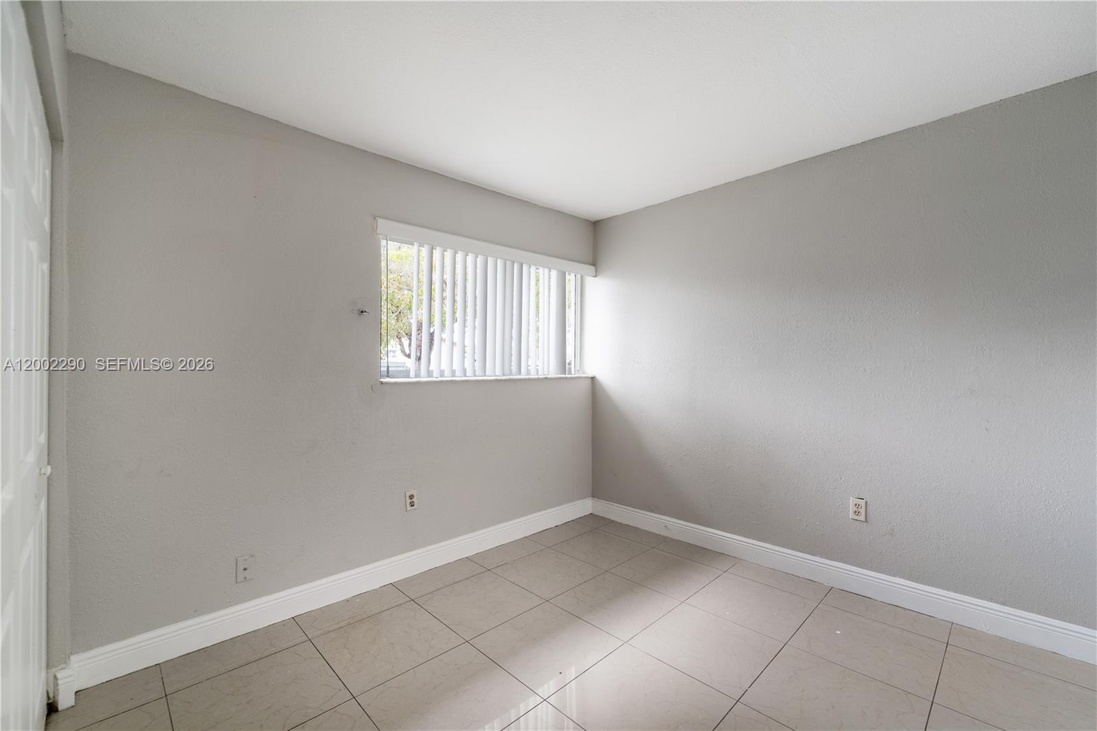 11310 Southwest 189th Street, Unit 11310 Miami, FL 33157 - Photo 6 of 24 an empty room with a window