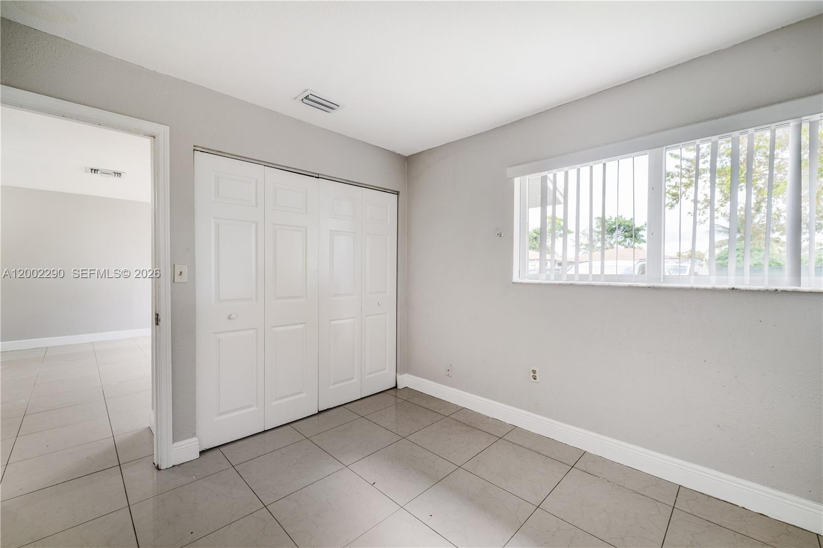 11310 Southwest 189th Street, Unit 11310 Miami, FL 33157 - Photo 7 of 24 a view of an empty room with a window