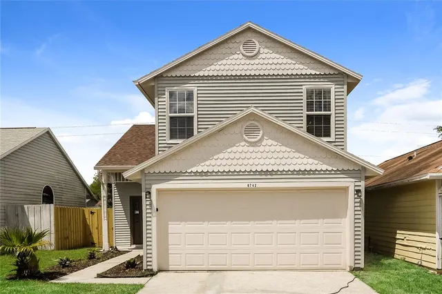 a front view of a house with garage