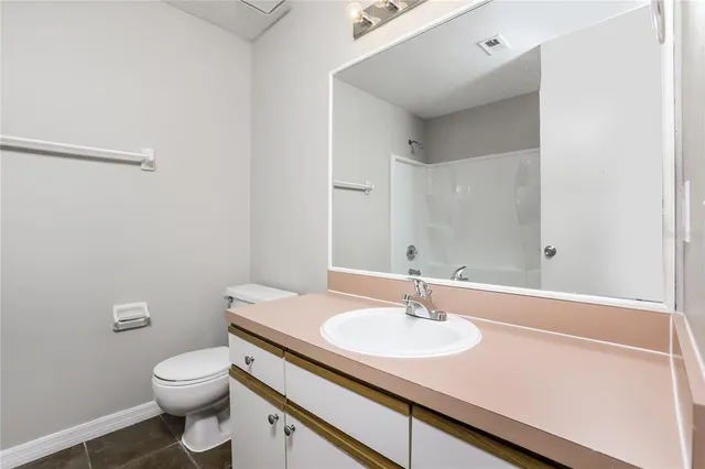 a bathroom with a sink toilet and a mirror