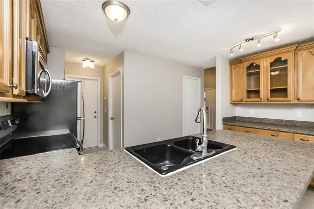 a view of a kitchen with a sink and a stove top oven