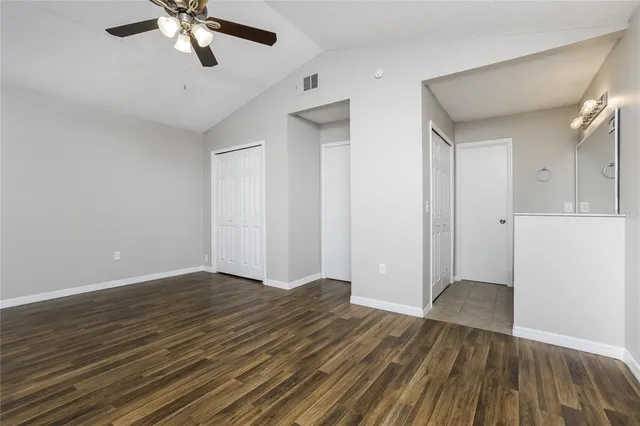 a view of an empty room with wooden floor