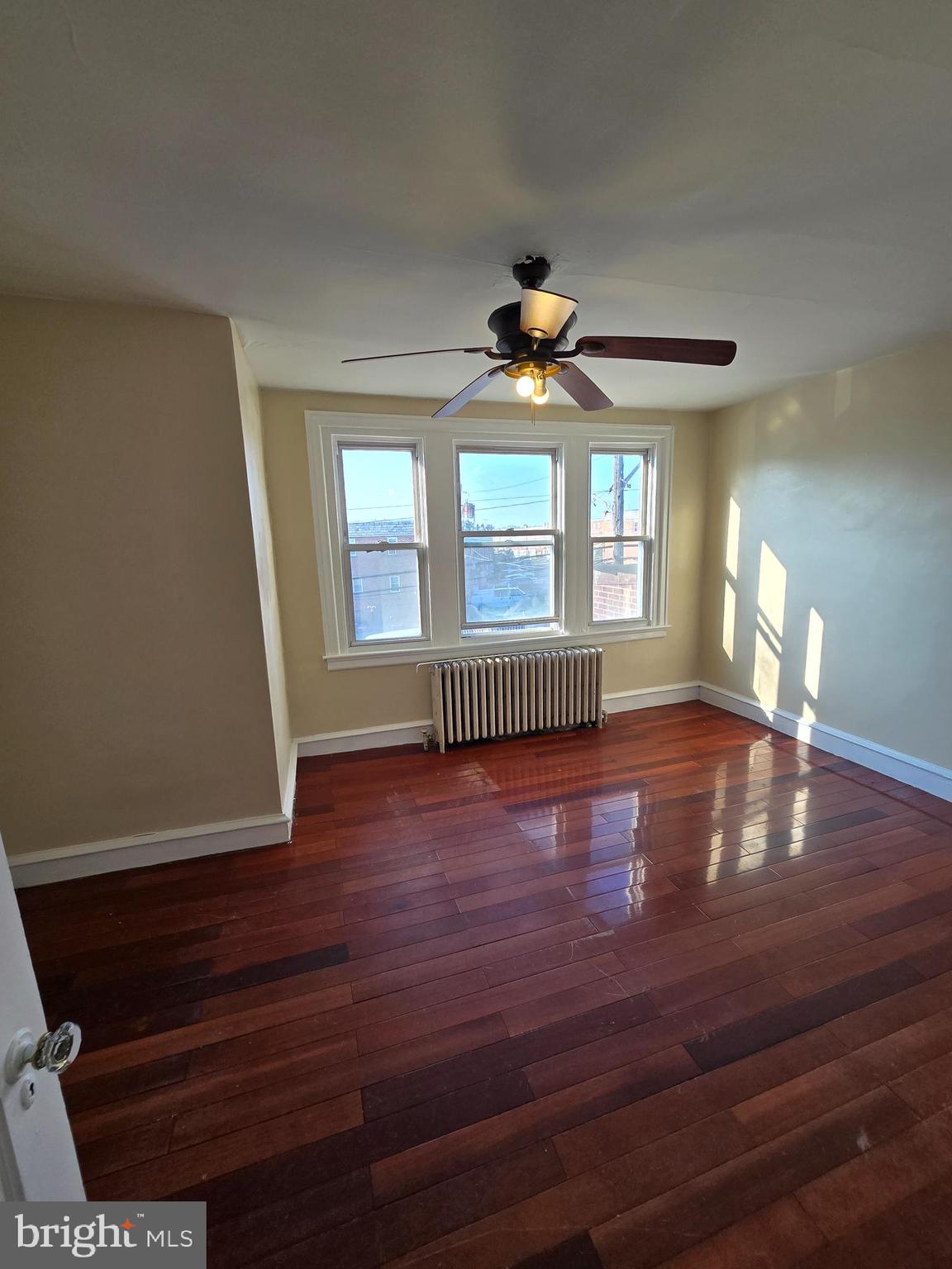 5215 North Tabor Road Philadelphia, PA 19124 - Photo 12 of 14 a view of an empty room with wooden floor and a window