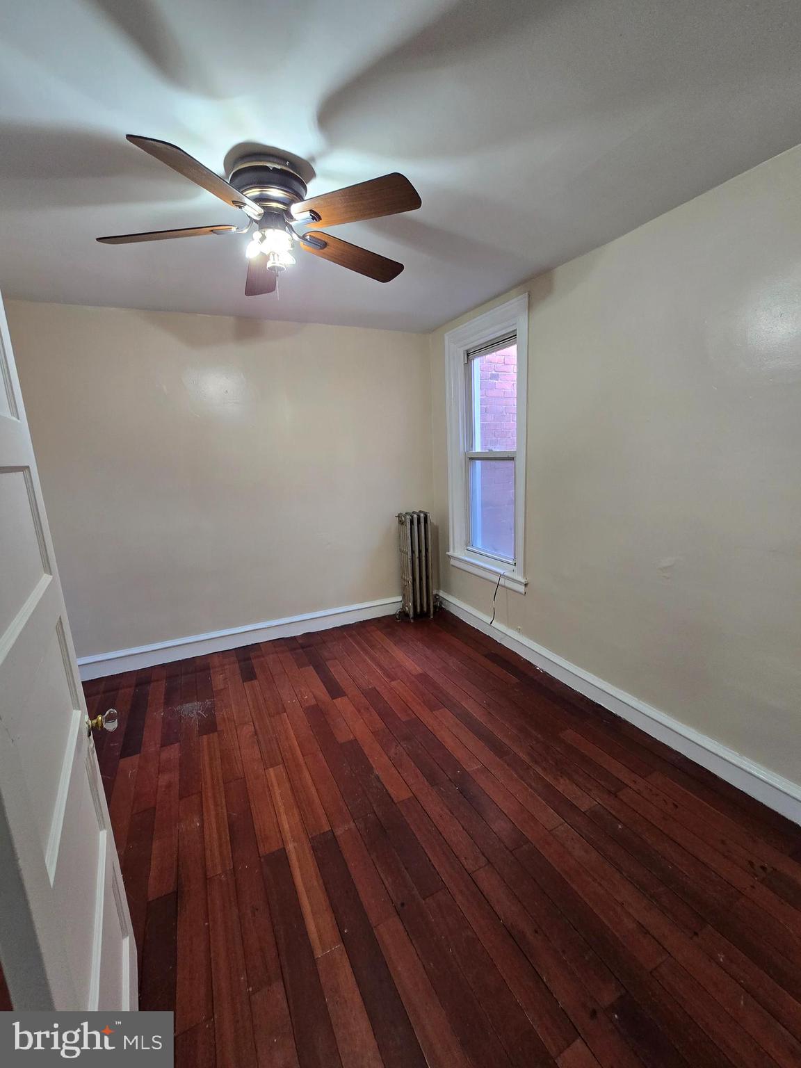5215 North Tabor Road Philadelphia, PA 19124 - Photo 10 of 14 wooden floor in an empty room with a window