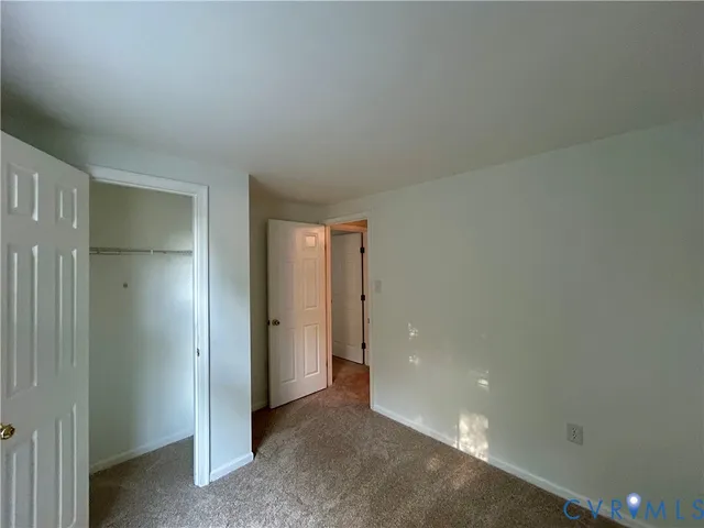 an empty room with closet area