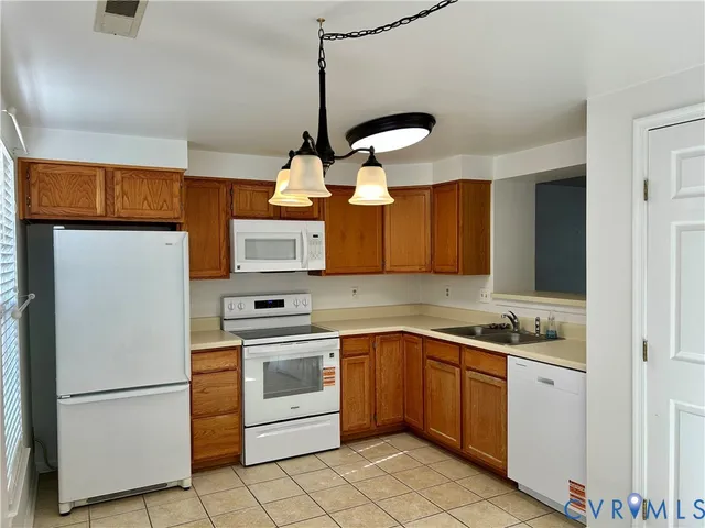 a kitchen with a sink stainless steel appliances and cabinets