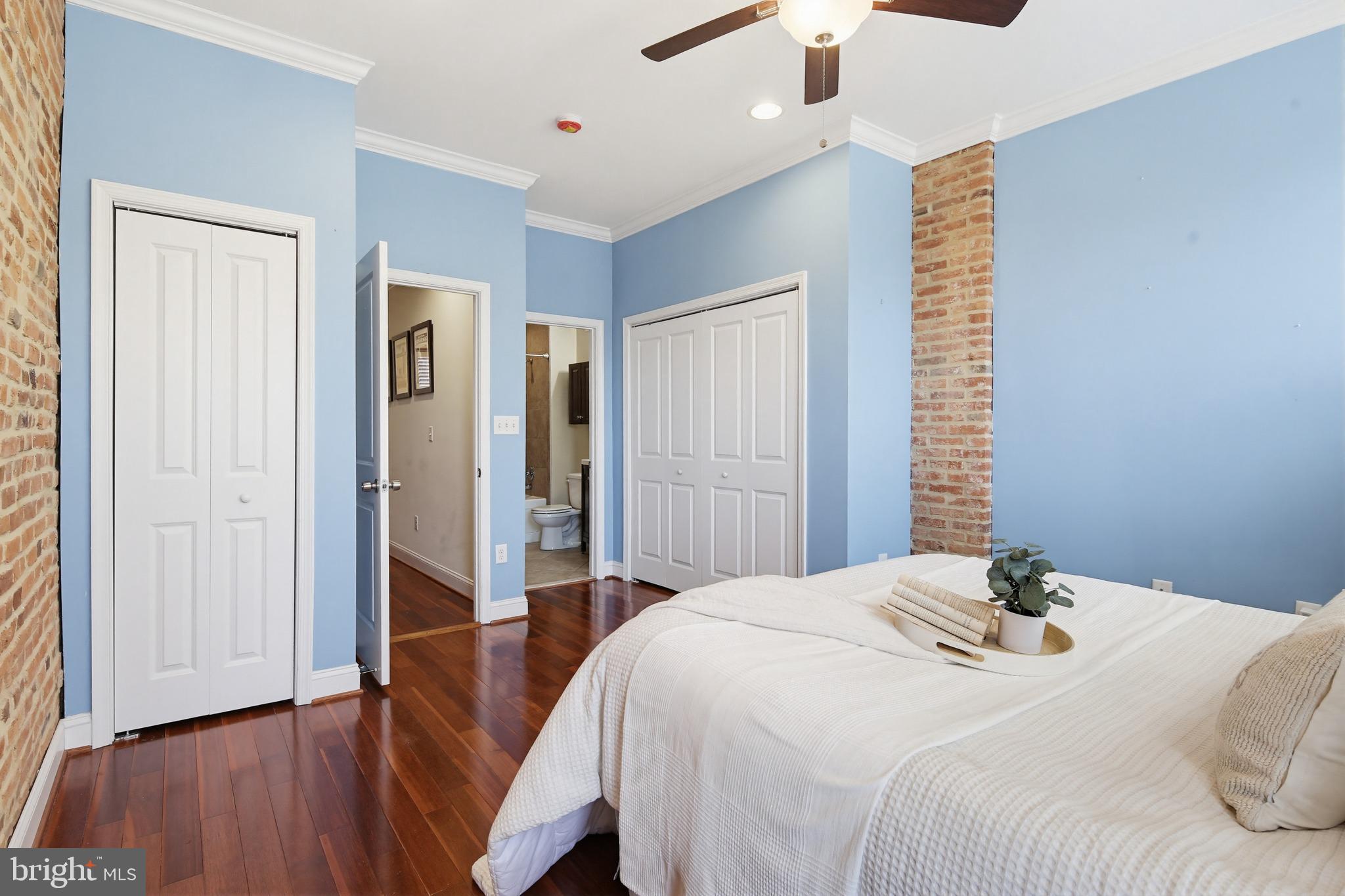 122 West Clement Street Baltimore, MD 21230 - Photo 15 of 40 a bedroom with a bed and wooden floor